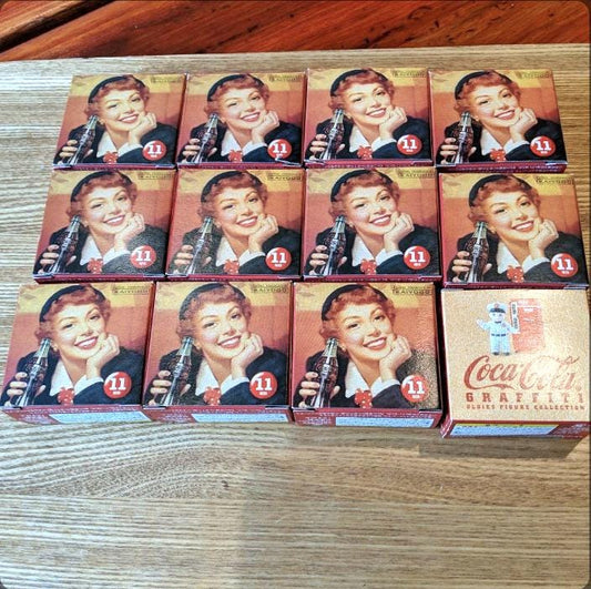 This is a complete set of 12 Coca-Cola Graffiti Miniatures, Vintage-Style, Unopened Bags & Original Boxes